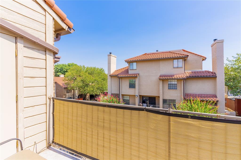 4777 Cedar Springs Road, Unit 8J Dallas, TX 75219 - Photo 21 of 30 a front view of a house with large windows and a small yard