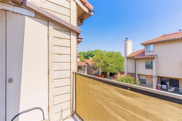 a view of a balcony with chair and table
