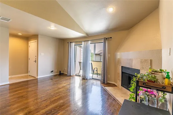 a living room with fireplace furniture and a wooden floor