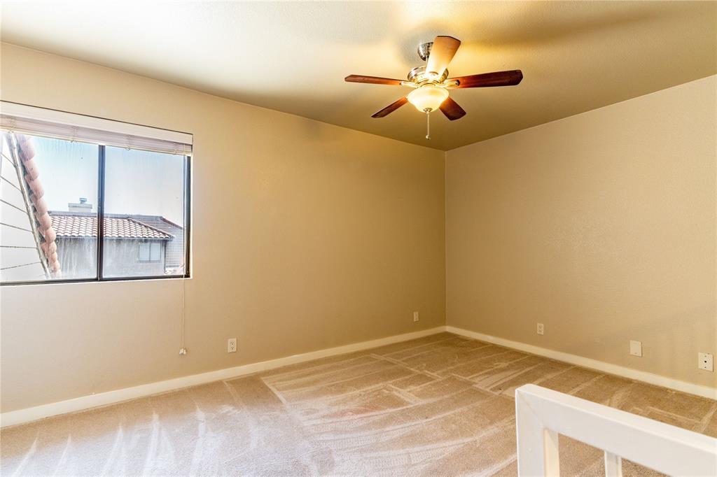 4777 Cedar Springs Road, Unit 8J Dallas, TX 75219 - Photo 6 of 30 a view of a room with a ceiling fan and a window