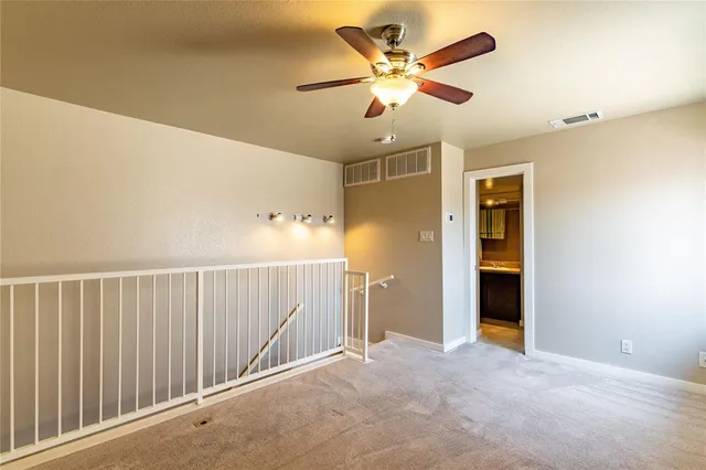 a view of a livingroom with a chandelier fan