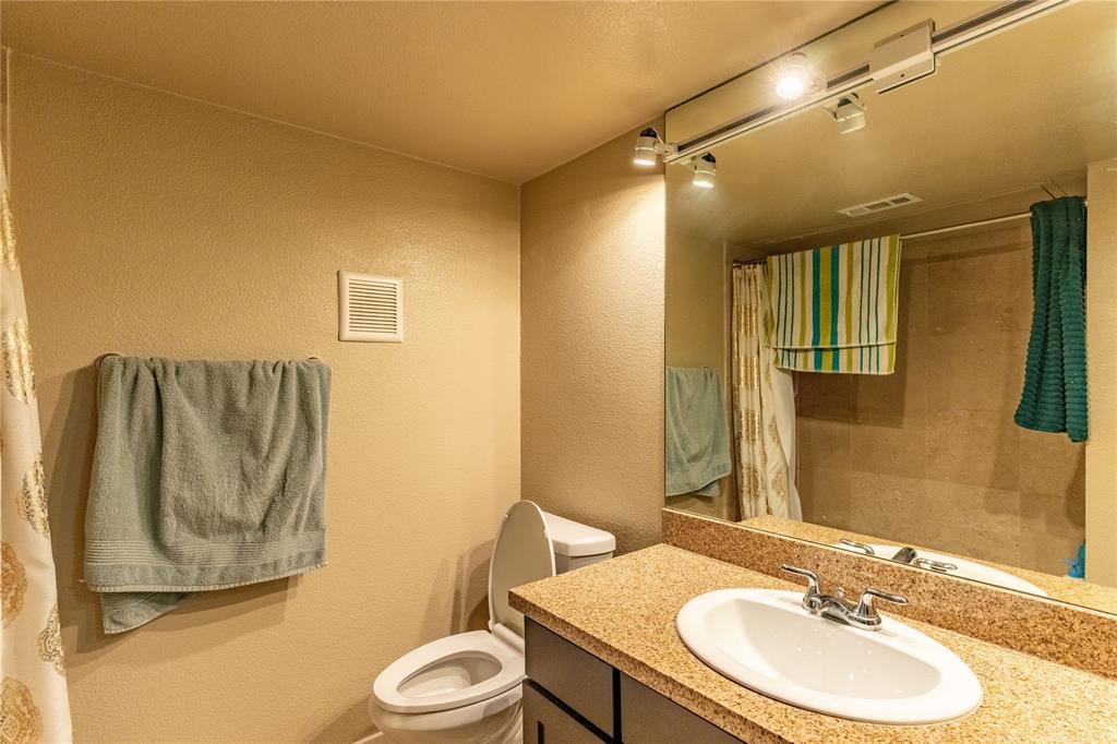 4777 Cedar Springs Road, Unit 8J Dallas, TX 75219 - Photo 9 of 30 a bathroom with a sink toilet and shower