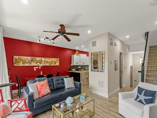 a living room with furniture and kitchen view