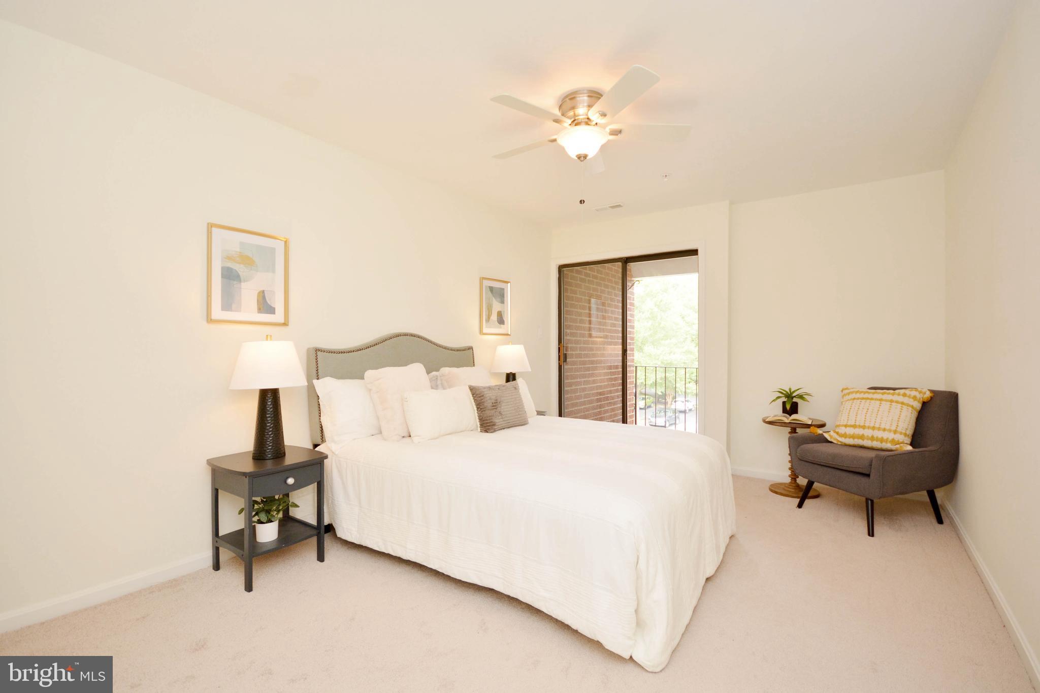 2900 Shipmaster Way, Unit 315 Annapolis, MD 21401 - Photo 11 of 39 a bedroom with a bed and a chandelier
