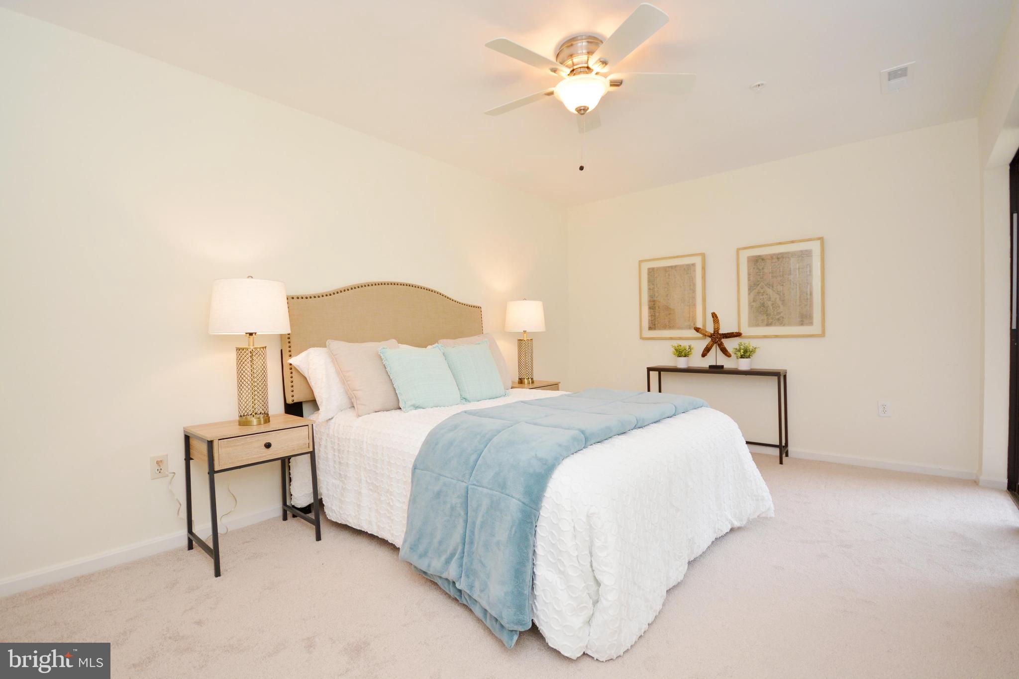 2900 Shipmaster Way, Unit 315 Annapolis, MD 21401 - Photo 15 of 39 a bedroom with a bed and a chandelier