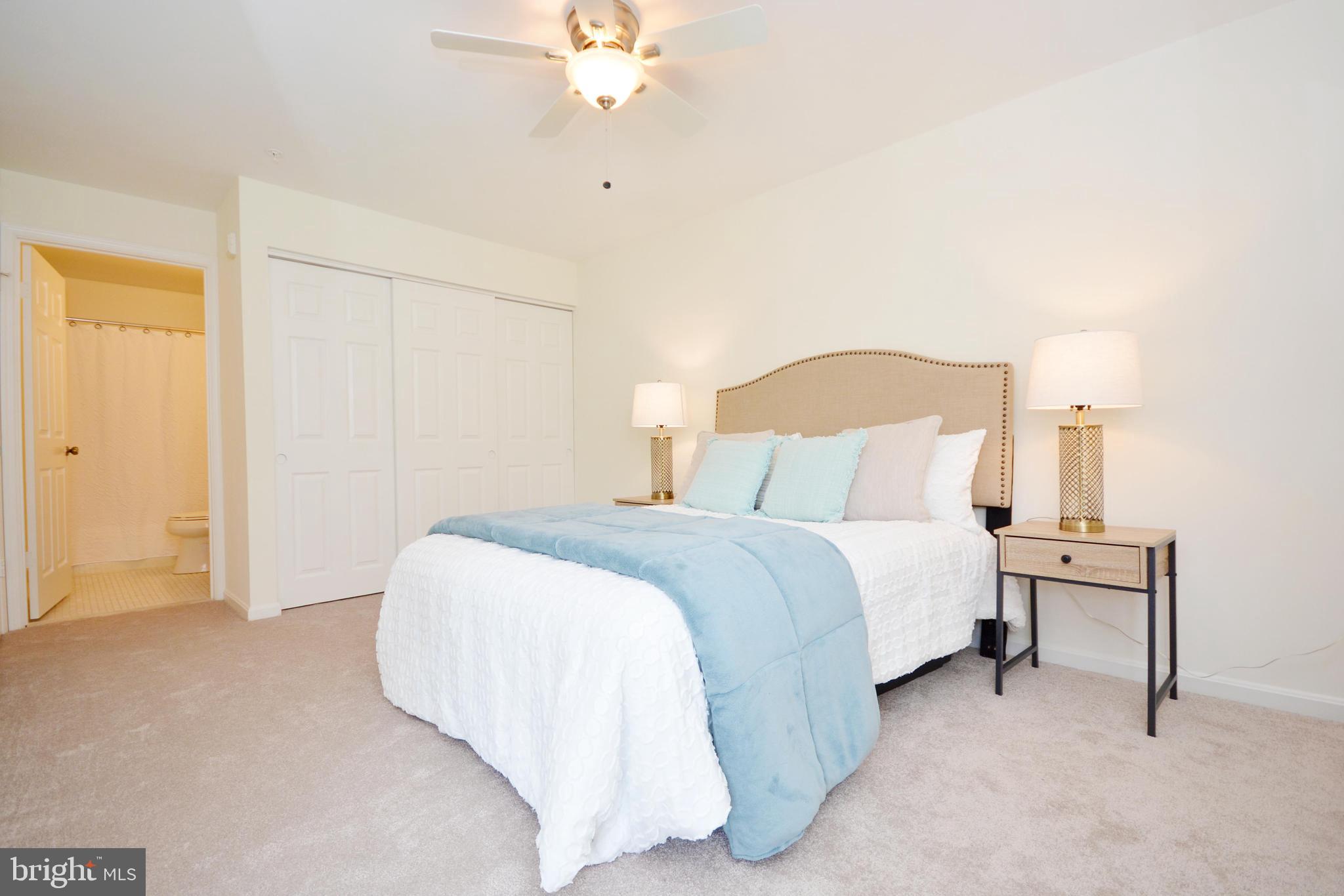 2900 Shipmaster Way, Unit 315 Annapolis, MD 21401 - Photo 16 of 39 a bedroom with a bed and a chandelier