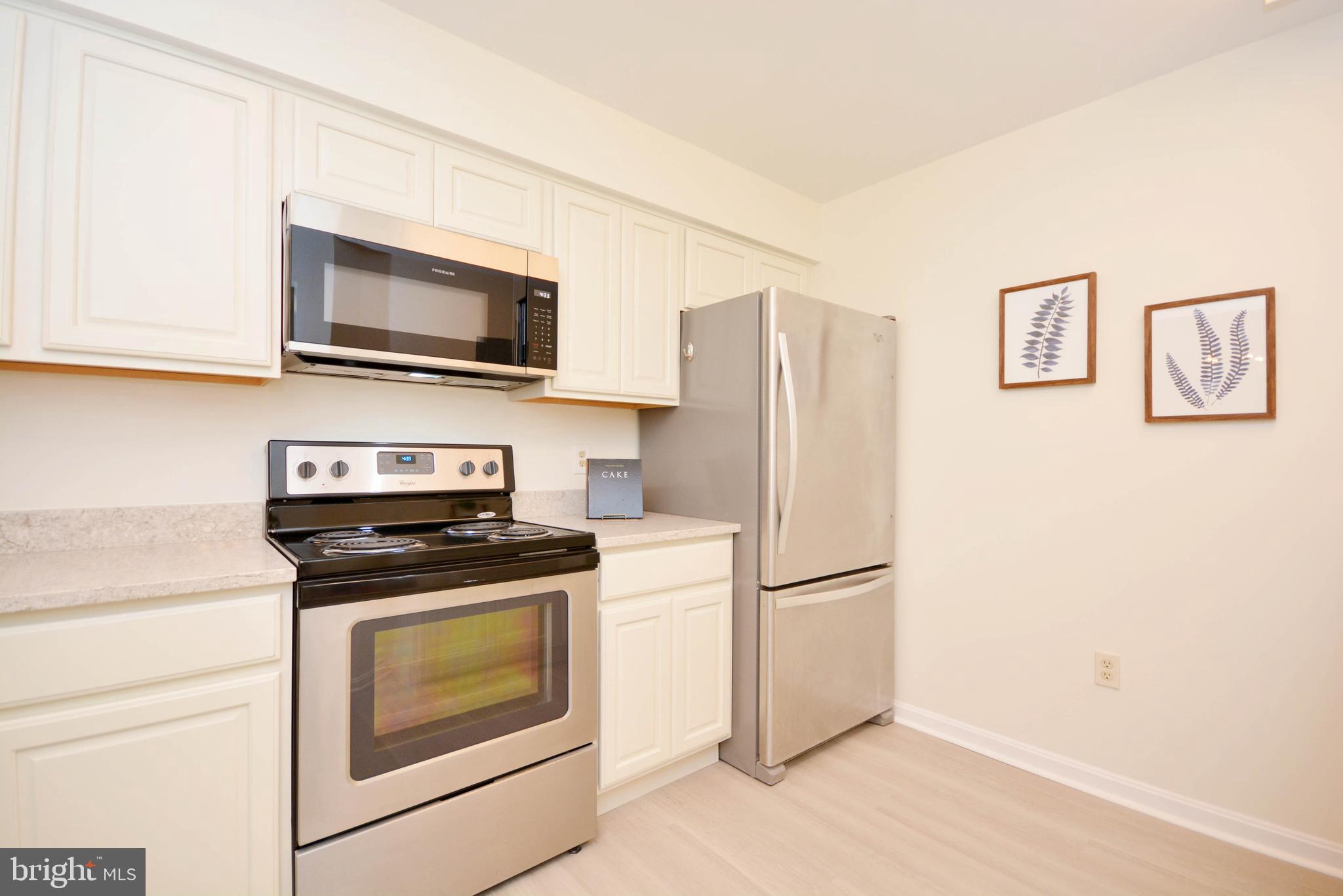 2900 Shipmaster Way, Unit 315 Annapolis, MD 21401 - Photo 5 of 39 a kitchen with a stove microwave and refrigerator