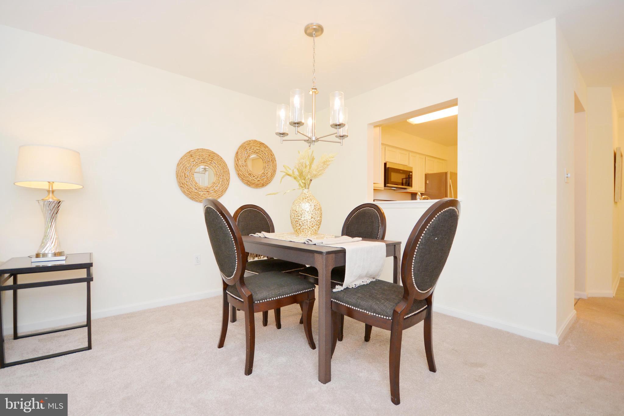 2900 Shipmaster Way, Unit 315 Annapolis, MD 21401 - Photo 10 of 39 a view of a dining room with furniture and a chandelier