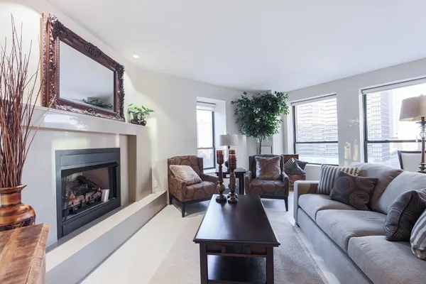 a living room with furniture a window and a fireplace