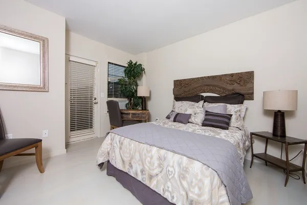 a bedroom with a bed and a chair