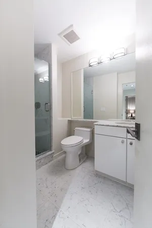 a bathroom with a toilet sink and shower