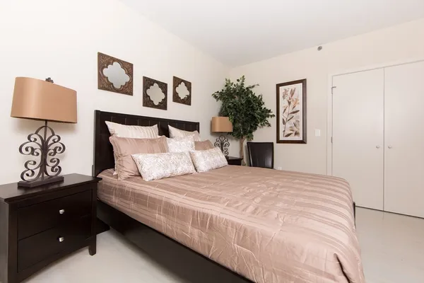 a bedroom with a bed and a night stand