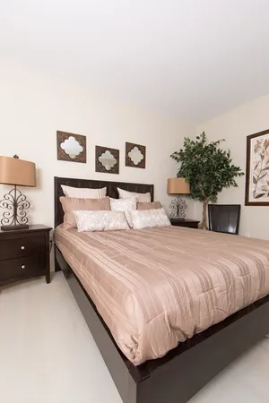 a bedroom with a bed and a night stand