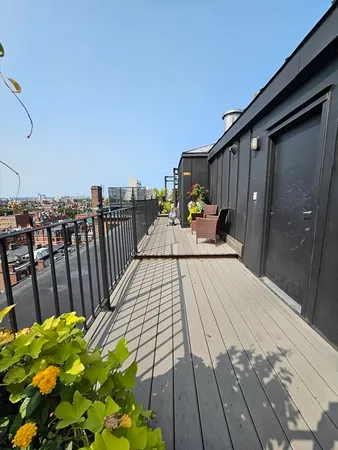 a terrace with outdoor seating and wooden floor