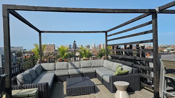 a outdoor living space with patio furniture and garden view