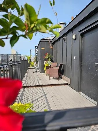 a view of a city with lots of residential buildings ocean and mountain view in back