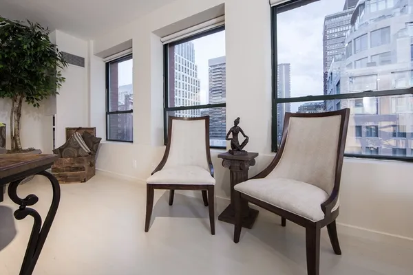 a view of a room with furniture and windows