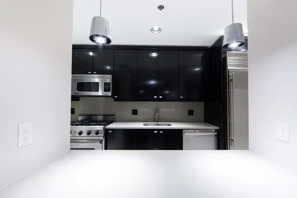 a kitchen with stainless steel appliances a sink a stove and cabinets