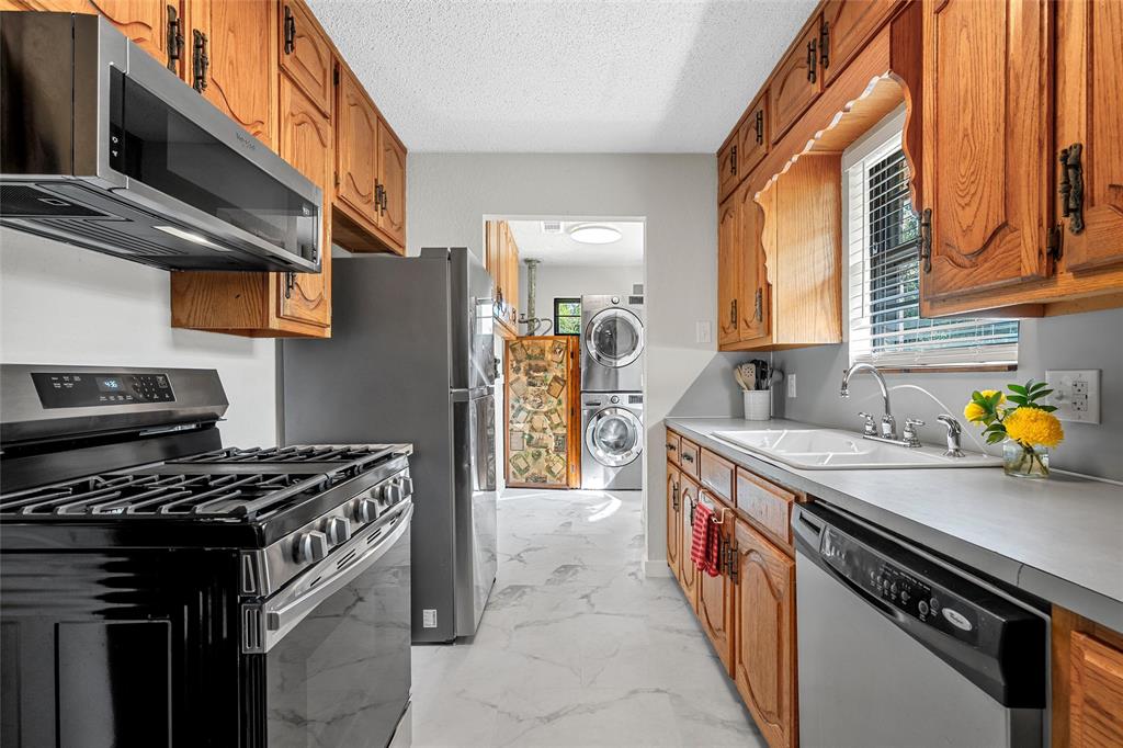 3000 North 15th A Street Waco, TX 76708 - Photo 8 of 24 a kitchen with stainless steel appliances a stove a sink and a cabinets