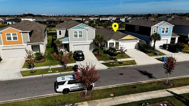 an aerial view of a house with a yard basket ball court and outdoor seating