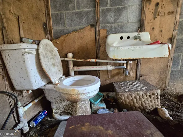 a bathroom with a sink toilet and mirror
