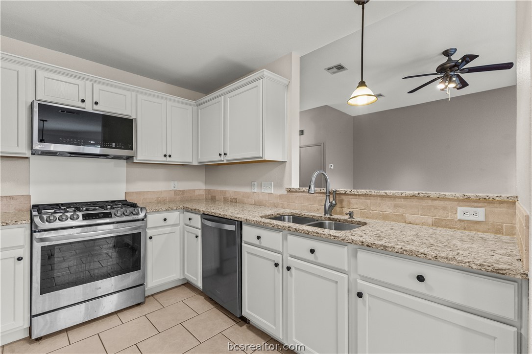 3709 Springfield Drive College Station, TX 77845 - Photo 7 of 23 a kitchen with granite countertop white cabinets white stainless steel appliances and a sink
