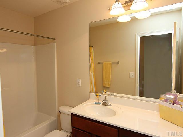 3335 Archdale Drive Raleigh, NC 27614 - Photo 12 of 15 a bathroom with a sink vanity granite tub shower and a mirror