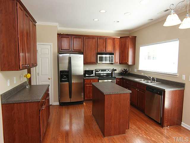 3335 Archdale Drive Raleigh, NC 27614 - Photo 4 of 15 a kitchen with stainless steel appliances granite countertop a refrigerator a sink dishwasher a stove and a oven with wooden floor