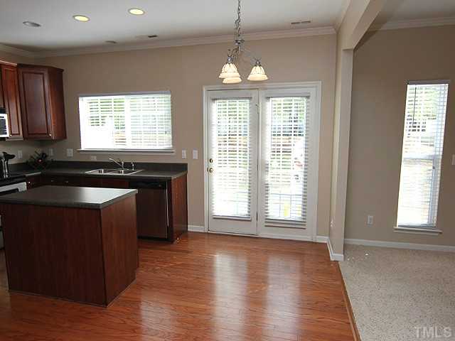 3335 Archdale Drive Raleigh, NC 27614 - Photo 5 of 15 a kitchen with wooden floors and black granite countertops