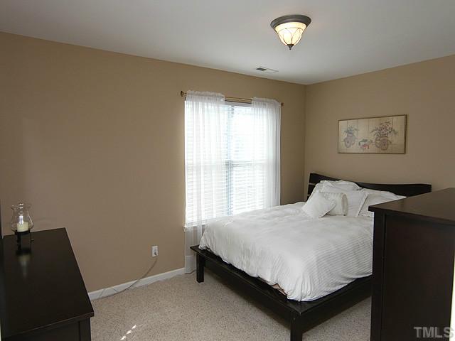 3335 Archdale Drive Raleigh, NC 27614 - Photo 9 of 15 a bedroom with a bed and a window