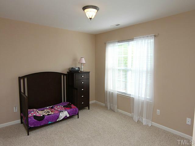 3335 Archdale Drive Raleigh, NC 27614 - Photo 10 of 15 a bedroom with a bed and window