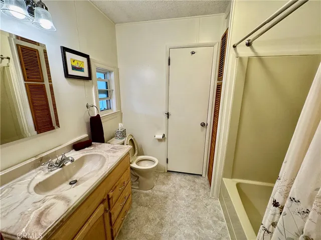 a bathroom with a sink a mirror and a toilet