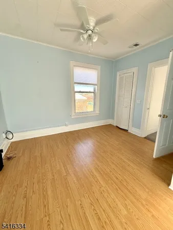 an empty room with fireplace and windows