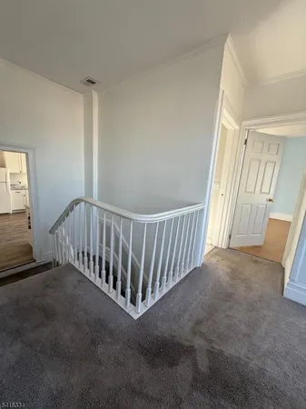 an empty room with windows and fireplace