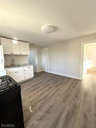 a kitchen with a stove and white cabinets