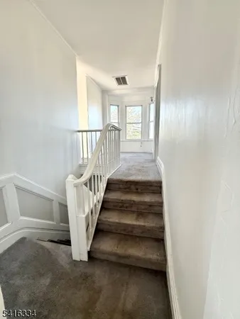 a view of an empty room with stairs