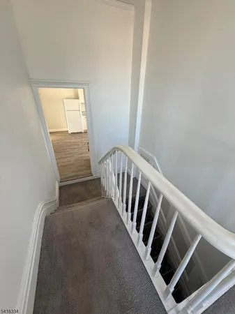 a view of an empty room with glass door and a window