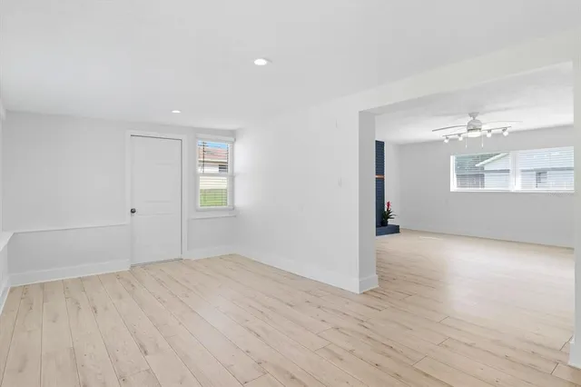 a view of empty room with wooden floor