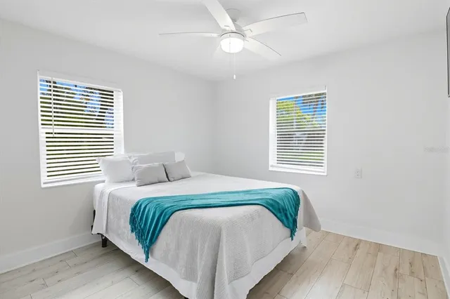 a bedroom with a bed and a painting on the wall