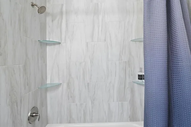 a bedroom with a bed and a potted plant