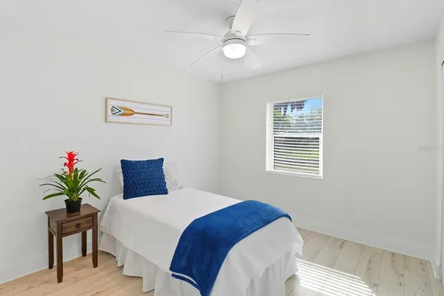 a bedroom with a bed and a fan