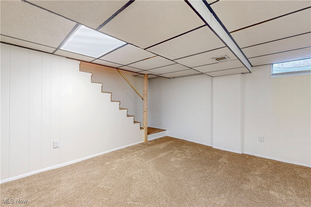 1723 Bantam Ridge Road Steubenville, OH 43953 - Photo 19 of 22 Below grade area featuring carpet floors, stairs, visible vents, and a drop ceiling