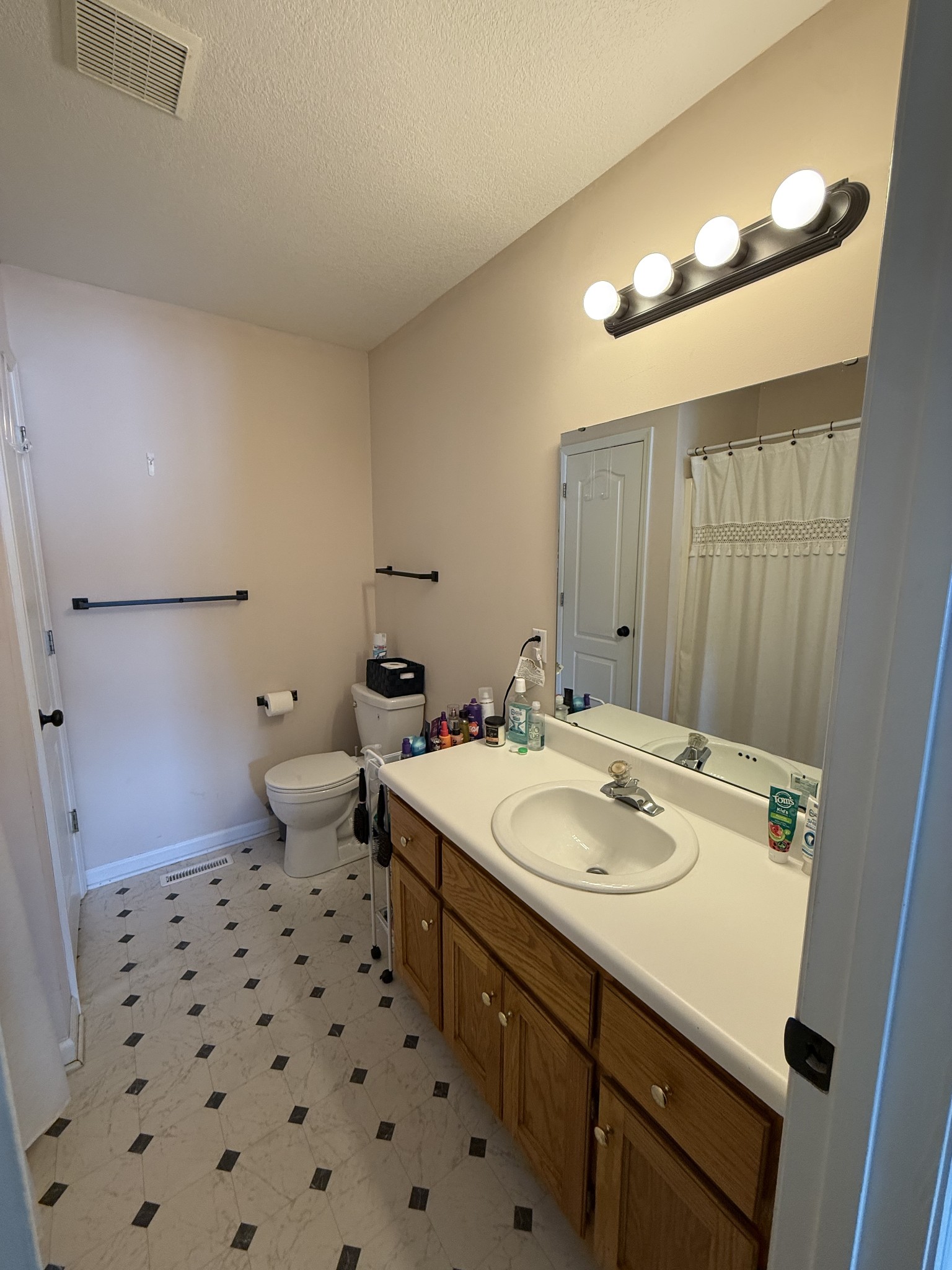 5716 Spring Creek Road Tullahoma, TN 37388 - Photo 6 of 8 a bathroom with a sink a toilet a mirror and shower