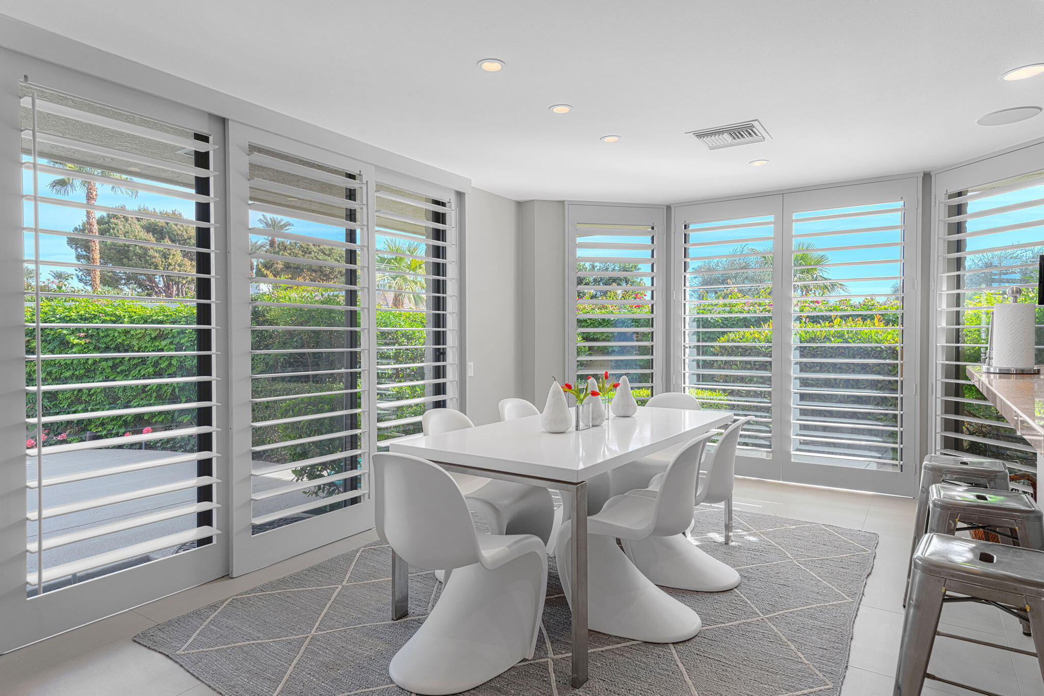 10 Creekside Drive Rancho Mirage, CA 92270 - Photo 18 of 32 a dining room with furniture and large windows