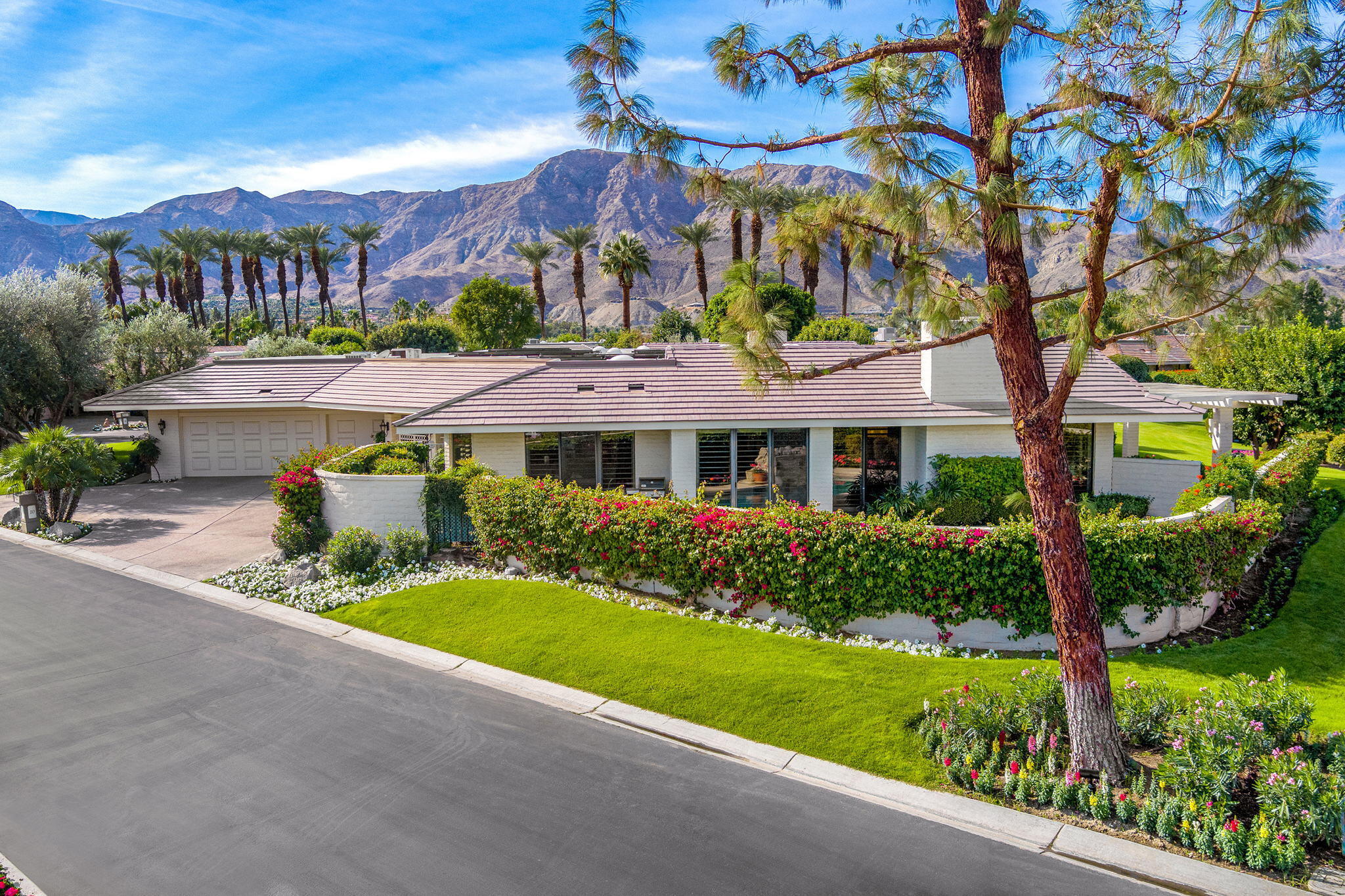10 Creekside Drive Rancho Mirage, CA 92270 - Photo 7 of 32 a front view of a house with a yard and potted plants
