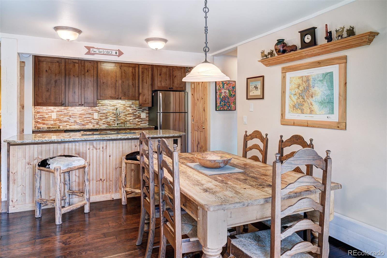 760 Columbine Road, Unit B6 Breckenridge, CO 80424 - Photo 12 of 39 a view of a dining room and livingroom with furniture wooden floor a chandelier