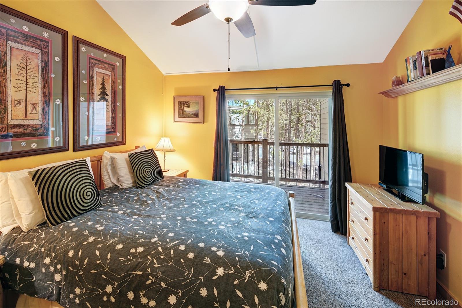 760 Columbine Road, Unit B6 Breckenridge, CO 80424 - Photo 15 of 39 a bedroom with a bed and a flat tv screen on dresser