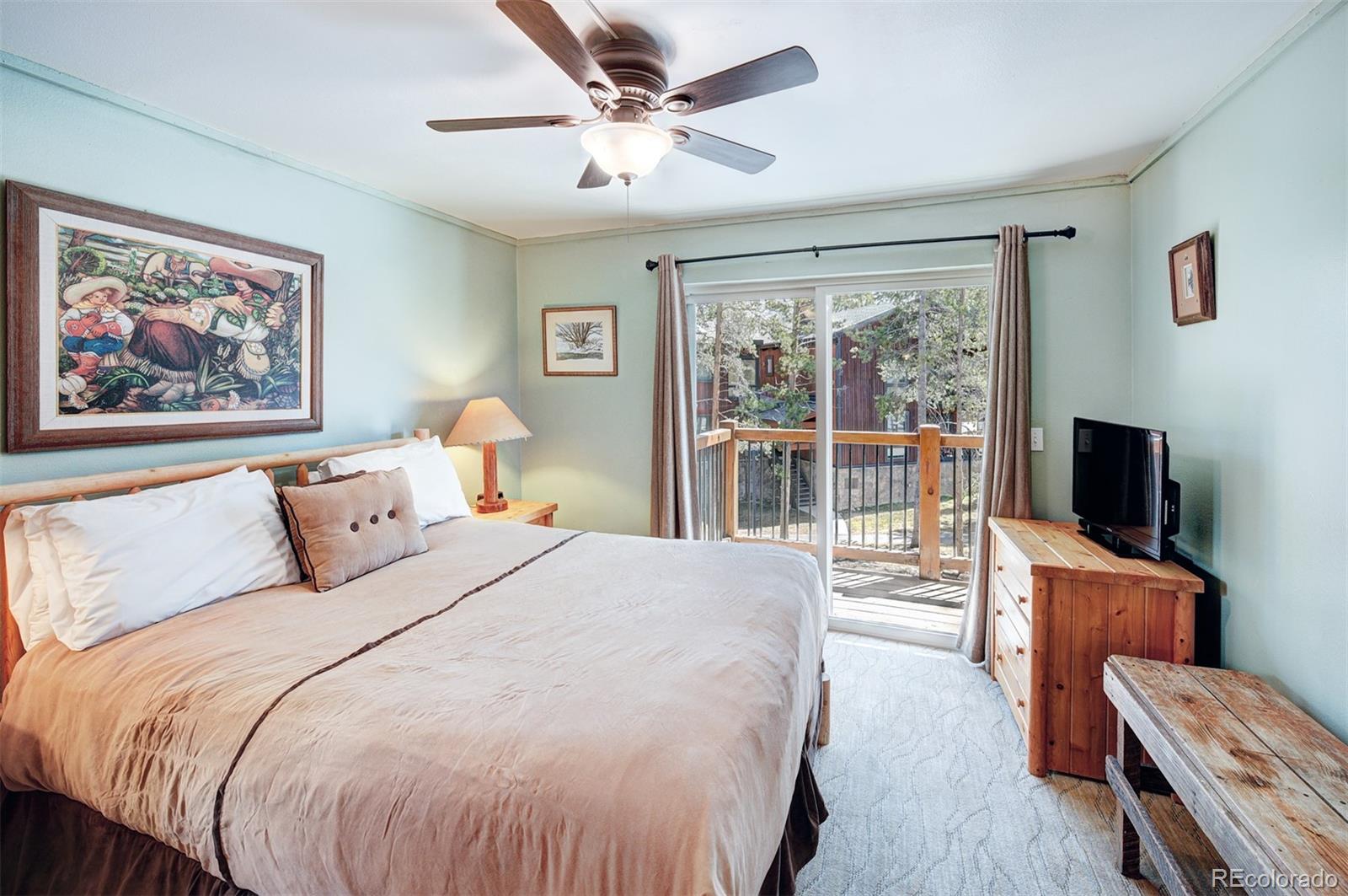 760 Columbine Road, Unit B6 Breckenridge, CO 80424 - Photo 20 of 39 a bedroom with a balcony a bed and a flat screen tv