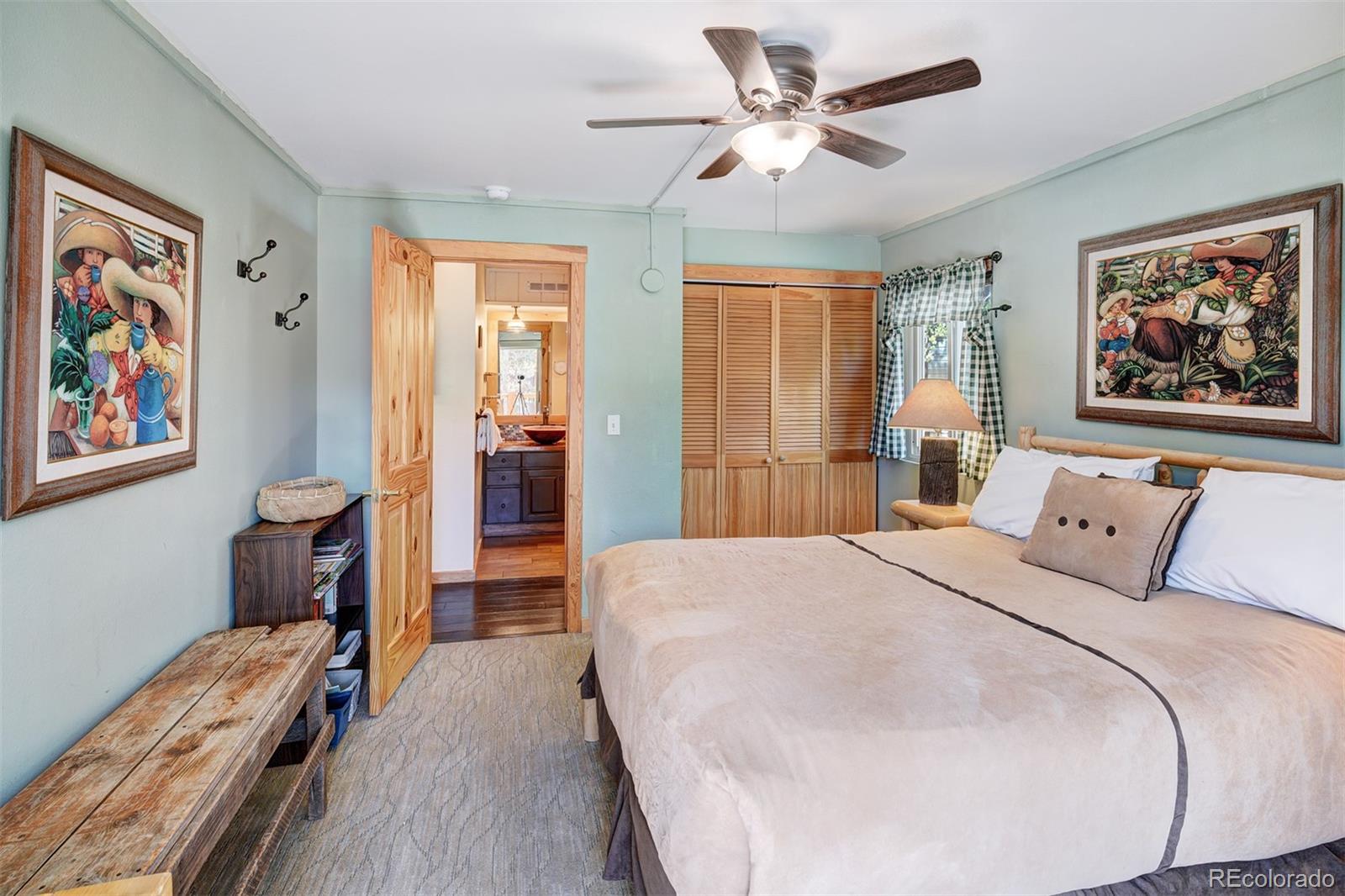 760 Columbine Road, Unit B6 Breckenridge, CO 80424 - Photo 21 of 39 a spacious bedroom with a bed and a chandelier