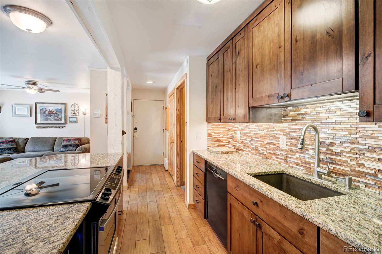 760 Columbine Road, Unit B6 Breckenridge, CO 80424 - Photo 3 of 39 a kitchen with stainless steel appliances granite countertop a sink stove and refrigerator